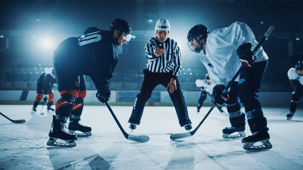 Ice Hockey Rink Arena Game Start: Two Players Brutal Face off, Sticks Ready, Referee is Going to Drop the Puck, Athletes Ready to Fight. Intense Game Wide of Energy Competition, Speed